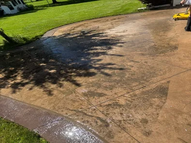 Patio before pressure washing with embedded grime