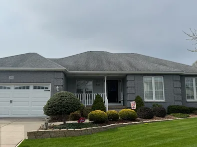 Roof before soft washing, covered in algae and dark stains